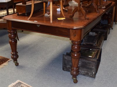 Lot 1430 - A Victorian mahogany extending dining table on turned legs, with brass capped castors