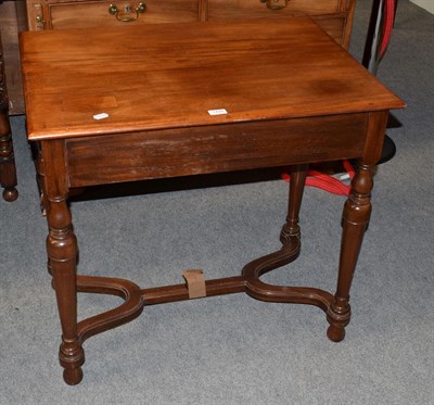 Lot 1439 - A mahogany side table on turned legs and a shaped stretcher