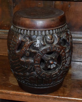 Lot 1227A - A Chinese carved hardwood barrel seat, decorated with dragons