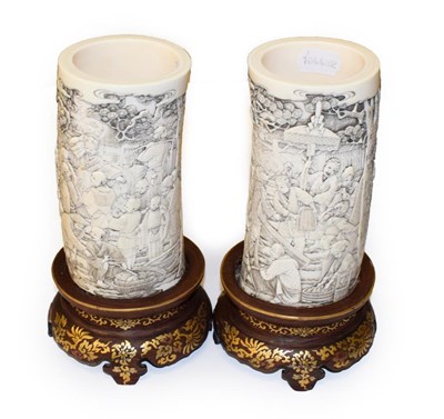 Lot 959 - A pair of Japanese tusk vases, Meiji period (1868-1912), each finely carved with traditional...