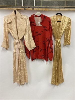 Lot 2007 - Early 20th Century Chinese Brocade Dressing Robes and Others, including two similar robes on a gold