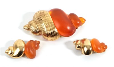 Lot 2086 - A Brooch, by Christian Dior, stylised in the form of a shell with orange plastic and gilt metal...