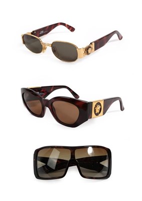 Lot 2112 - Two Pairs of Gianni Versace Sunglasses, with tortoiseshell and gilt mounted frames, Another Pair of