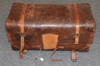 Lot 2155 - 19th century brown leather trunk, hinged and enclosing a blue and white striped cotton lining...