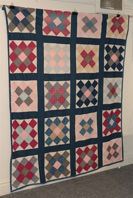 Lot 2169 - A block patchwork bed cover, incorporating sprigged, plain, checked and striped cottons, 170cm...