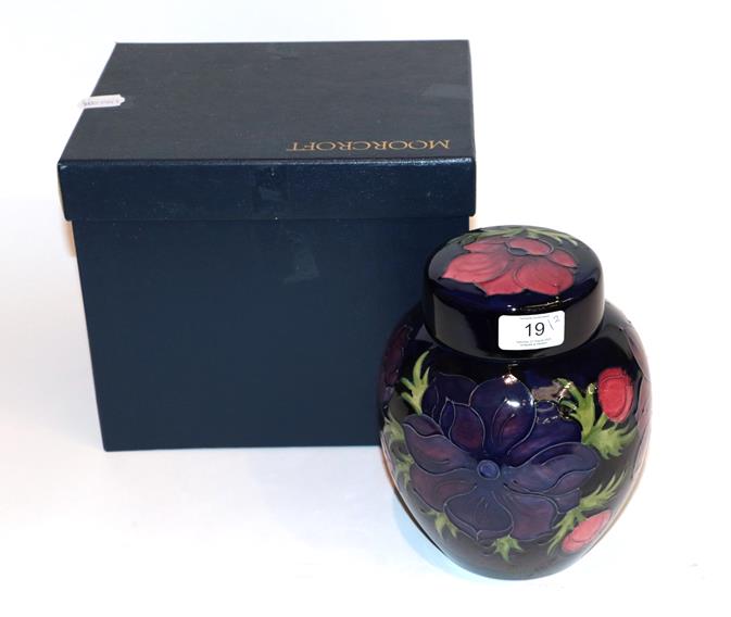 Lot 19 - Moorcroft Anemone ginger jar and cover, on a blue ground, with box