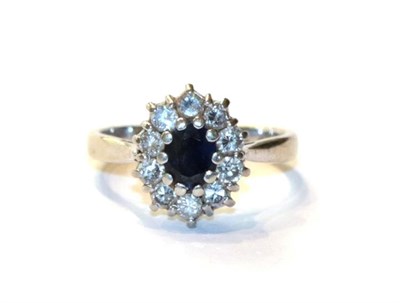 Lot 41 - A sapphire and diamond cluster ring, finger size K