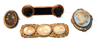 Lot 49 - A collection of four brooches comprising of a Victorian tortoiseshell cameo buckle, with three...