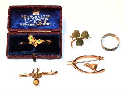 Lot 50 - A 9 carat gold swallow bar brooch, length 4.2cm; a 9 carat gold shamrock brooch; a butterfly...