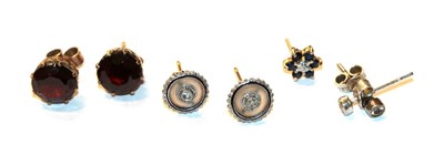 Lot 51 - A pair of garnet solitaire earrings, stamped '9CT'; a pair of diamond solitaire earrings, unmarked