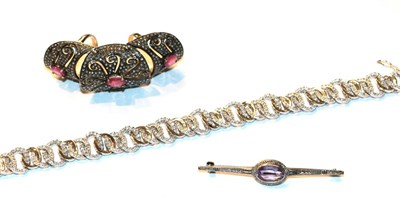 Lot 53 - An amethyst bar brooch, stamped '925', length 5.8cm; a paste full finger ring; and a silver...
