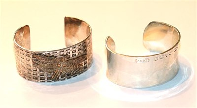 Lot 57 - A plain polished bangle, stamped '1997 Tiffany & Co 925'; and another with an applied butterfly...