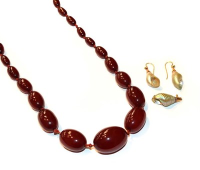 Lot 67 - A pair of shell drop earrings, length 3.3cm; a shell brooch, length 2.8cm; and a red amber bead...