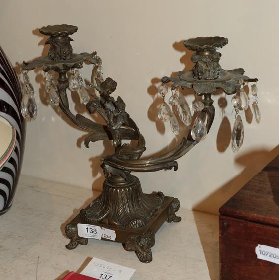 Lot 138 - A patinated bronze twin light candelabra