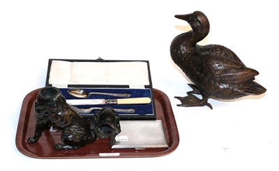 Lot 174 - A bronze dog form inkwell, silver cigarette case, two cased plated flatware