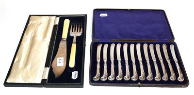 Lot 219 - A cased set of twelve silver handled tea knives and a cased silver and ivorine fish service