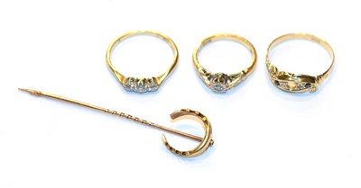 Lot 235 - A diamond three stone ring, stamped '18CT', finger size P; a diamond solitaire ring, stamped...