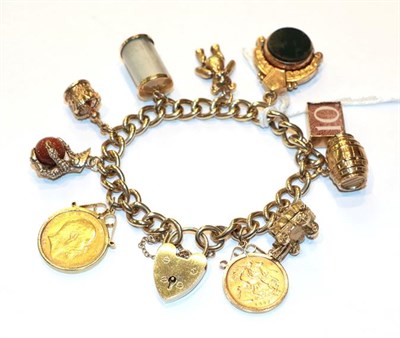 Lot 243 - A charm bracelet, stamped '9' and '.375', hung with ten charms including a teddy bear, a barrel, an