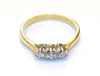 Lot 252 - An 18 carat gold diamond three stone ring, finger size O