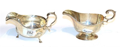 Lot 282 - Two George V silver sauceboats, one by Adie Brothers, Birmingham, 1934, boat-shaped and on...