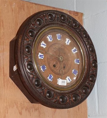 Lot 355 - An oak wall clock with blue enamel chapters