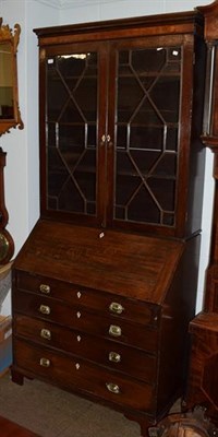Lot 1236 - A George III oak bureau bookcase, associated top, twin astragal glazed doors above fall flap,...