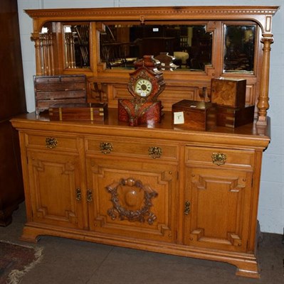 Lot 1239 - A Maple & Co light oak sideboard, enclosed gallery back with triple bevelled glass mirrors,...