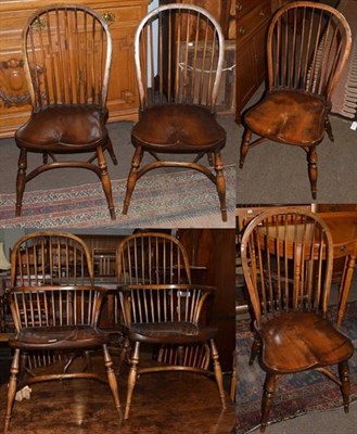 Lot 1273 - A set of six 19th century style elm seated stick back chairs including two carvers, by Walker's...