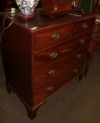 Lot 1289 - A George III mahogany chest of drawers, two short over three long graduated drawers, oval brass...