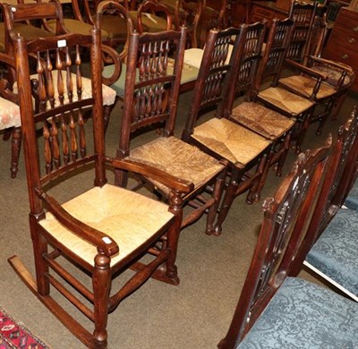 Lot 1295 - A set of four 19th century rush seated spindle back chairs, together with a similar carver, rocking