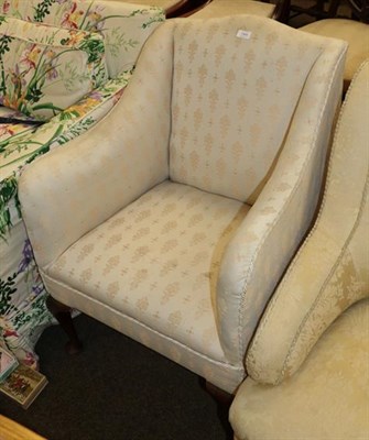 Lot 1304 - A 19th century mahogany framed armchair in ivory coloured floral upholstery, with cabriole legs