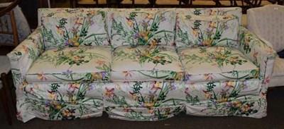 Lot 1305 - A three-seater sofa, upholstered in floral fabric