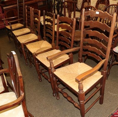 Lot 1308 - A set of six rush seated ladder back chairs including two carvers (6)