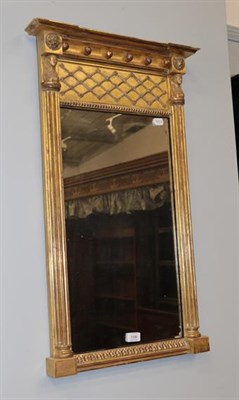 Lot 1330 - A Regency Egyptian Revival gilt wood pier glass mirror, 82cm high by 49cm wide