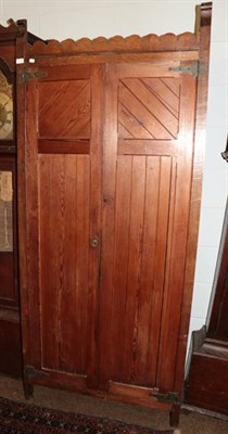 Lot 1334 - A Victorian pitch pine cupboard in the neo-Gothic style, twin panelled doors with shaped metal...