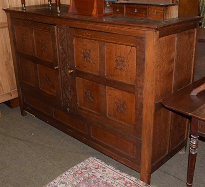 Lot 1342 - An oak chancel cupboard, with twin doors, 188cm wide