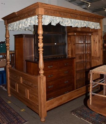 Lot 1343 - A pine kingsize full tester bed, panelled headboard and canopy, 224cm high by 230cm long by...