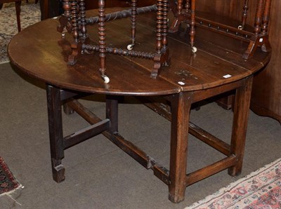 Lot 1348 - An 18th century and later oak drop leaf table, 137cm diameter