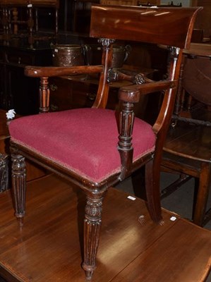 Lot 1358 - A mid-19th century mahogany open arm chair, the crest rail above a carved stretcher, the out...