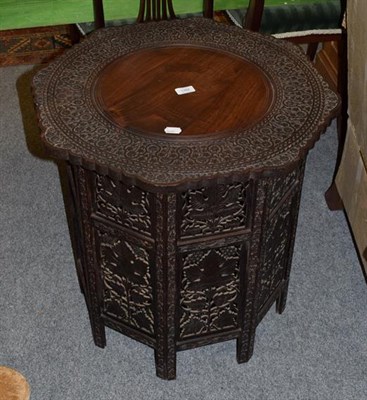 Lot 1382 - An Indian carved hardwood folding table