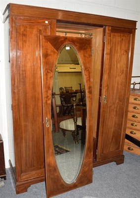 Lot 1395 - An Edwardian triple door mirrored wardrobe, 198cm high