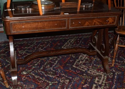 Lot 1398 - A mahogany writing table with lyre supports and stretcher, 112cm wide