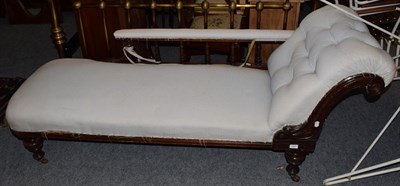 Lot 1407 - A Victorian ebonised chaise lounge, with button back upholstery