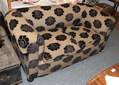 Lot 1427 - A Victorian Chesterfield settee, re-upholstered in black floral fabric