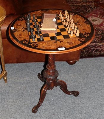 Lot 1432 - A mahogany inlaid tripod games table, together with a carved wooden chess set, with box