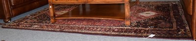 Lot 1442 - A brown and red ground rug with central medallions and an outer border depicting animals, 260cm...