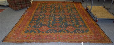 Lot 1465 - Ushak carpet, the field of serrated ruler of leaves enclosed by stylised vine borders, 358cm by...