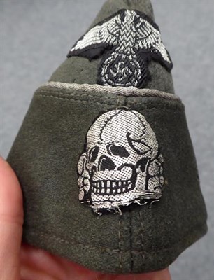 Lot 134 - A German Third Reich SS Officer's Overseas Cap, in field grey wool mix, the fold-down sides...