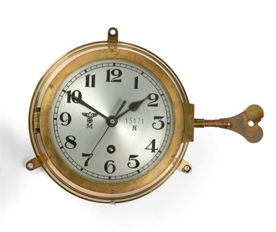 Lot 145 - A German Third Reich Kriegsmarine Bulk Head Clock, in a brass drum case, the 14.5cm circular...