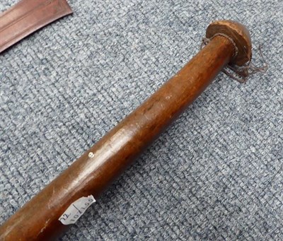 Lot 205 - A Vanuatu War Club, of dark red hard wood, with three conical protrusions to the head (one...